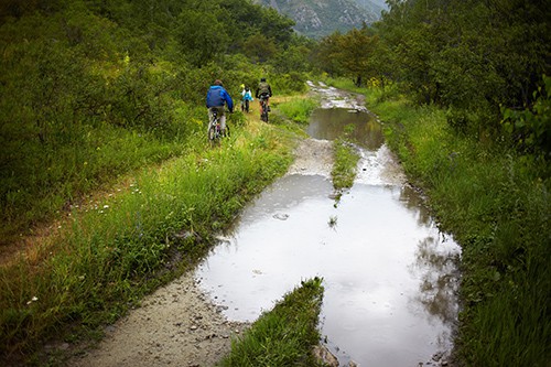 The group of bikers on the old mountain road in the rain