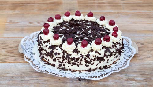Black Forest cake on rustic wood.