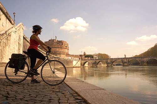 cyclist looking at river in italy