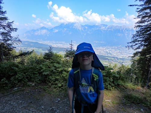 young boy posing on a mountain trail